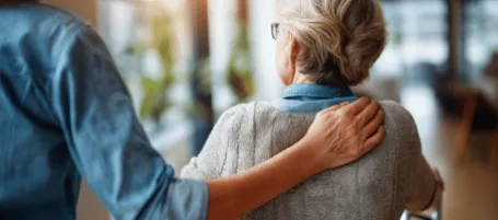 elderly woman walking carefully at home