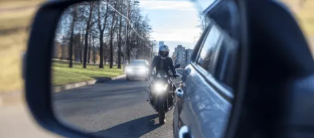 traffic queue with a motorcycle filtering past