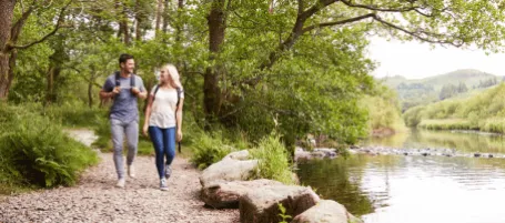 Walking alongside river bank