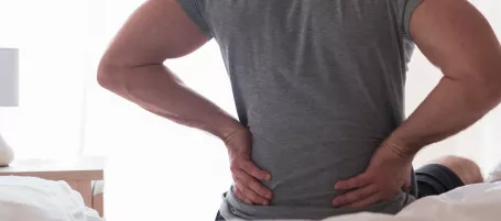 Woman holding onto her back