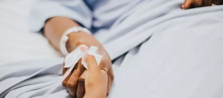 Image of hand in hospital bed